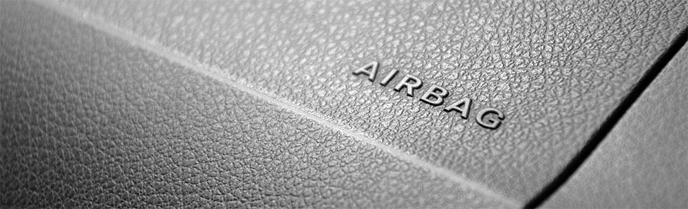 Close up photo of a car dashboard labeled where the airbag is located